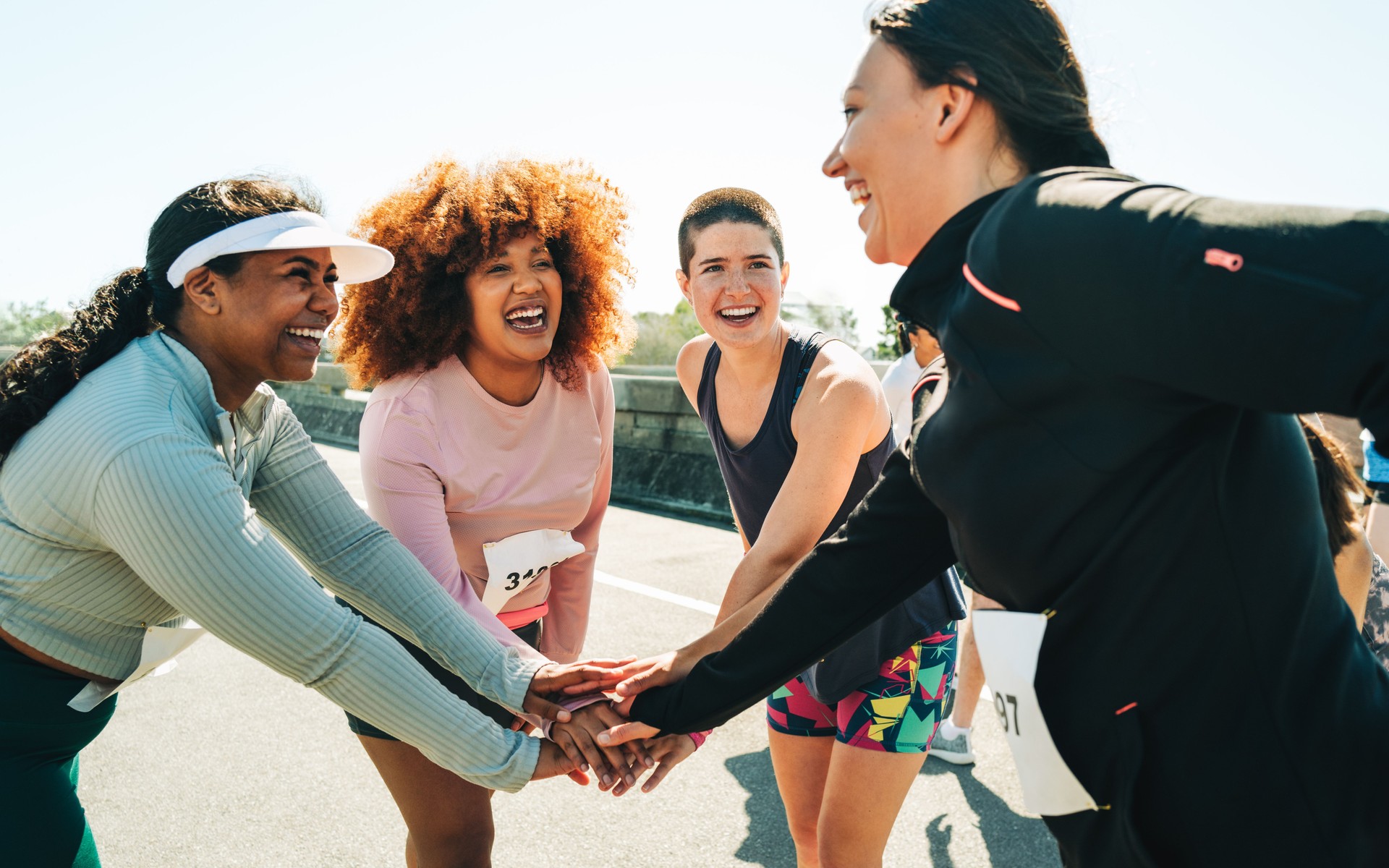 Group of diverse female runners bonding before a race